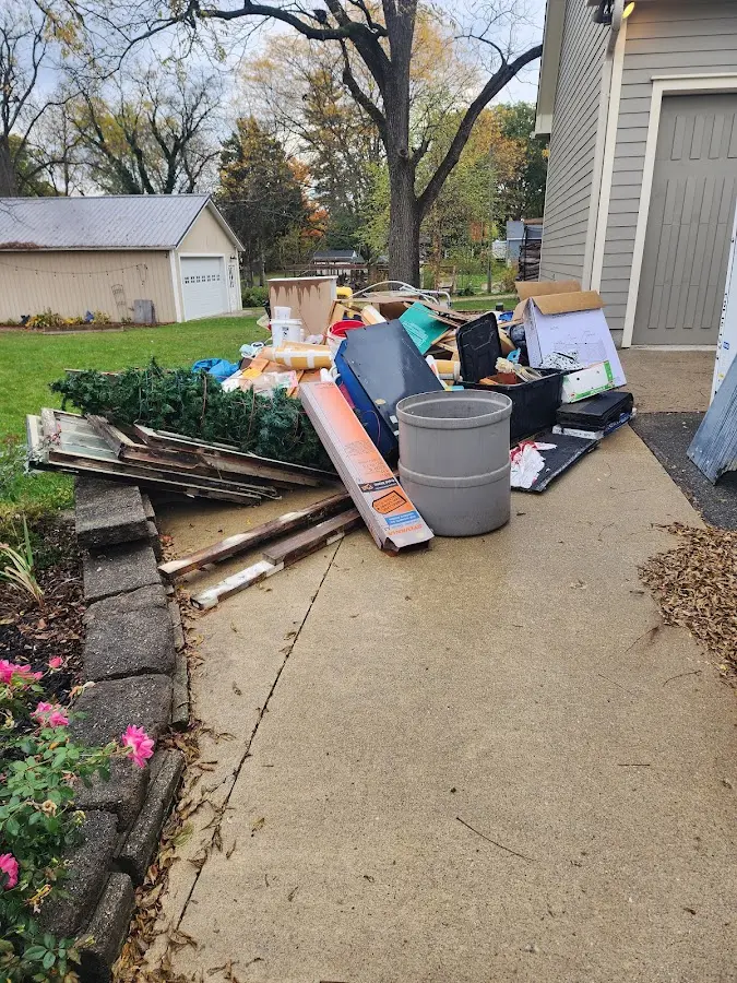 Dumpster being loaded with debris for Residential Dumpster Rental in Brownfields